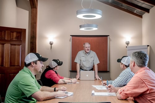 Landscape company team members reviewing customer survey results