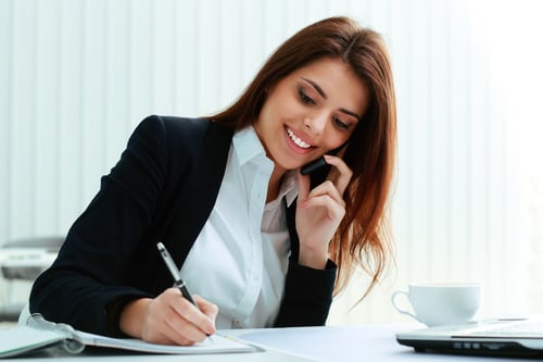 Woman on phone surveying landscape customers